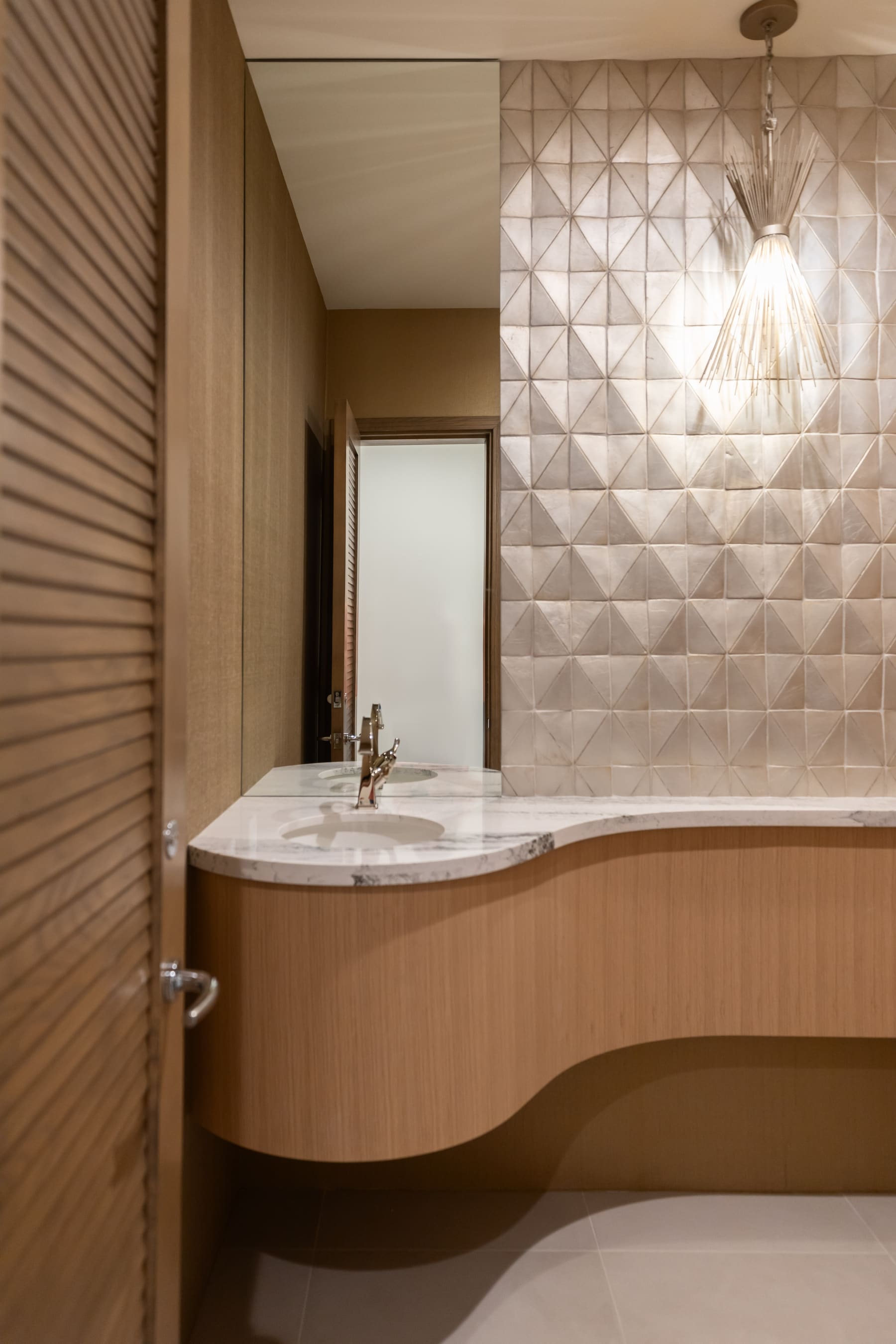 Curved floating white oak powder bath vanity with marble top — Phoenix custom cabinetry