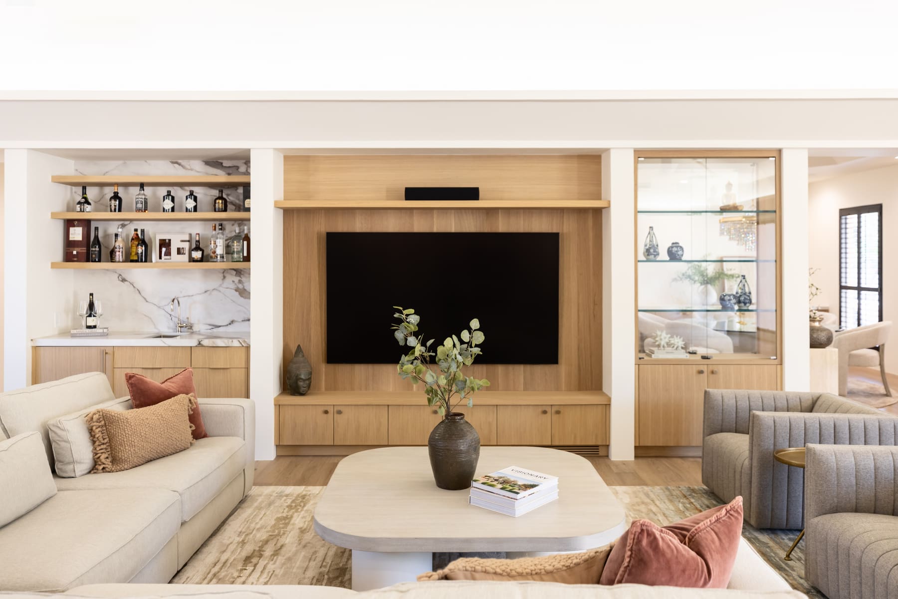White oak media wall with bar nook and glass display cabinet — Phoenix custom cabinetry